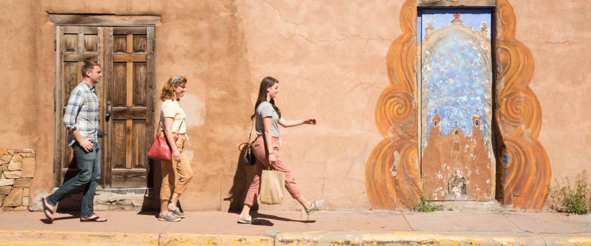 People walking on a sidewalk in Santa Fe, NM