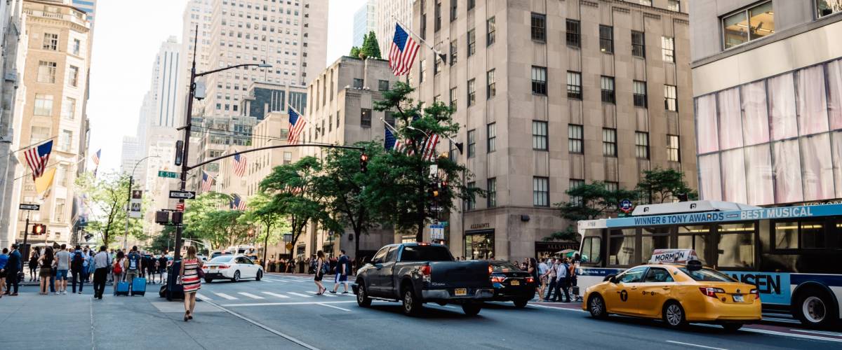 Scenic view of Fifth Avenue with people and yellow cabs