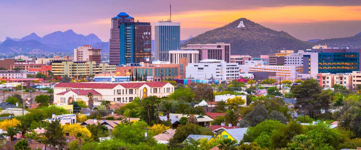 Tucson, Arizona, USA downtown city skyline with mountains at twilight.